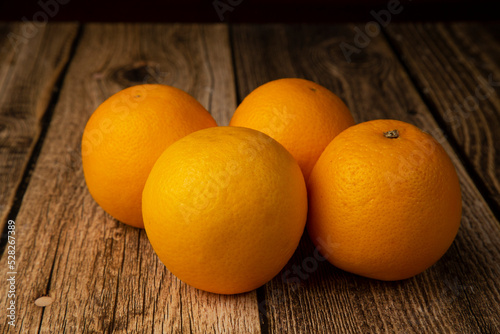 Oranges on a wooden background. An icon for a store for selling oranges.