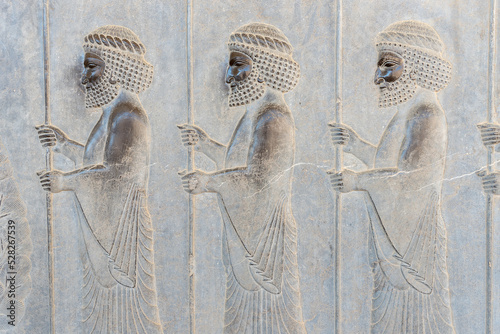 Bas-relief decoration along stairs from Darius palace to Palace of Xerxes. Ancient ruins of Persepolis near Shiraz in southern Iran. This UNESCO World Heritage Site showcases beautiful ruins from the 