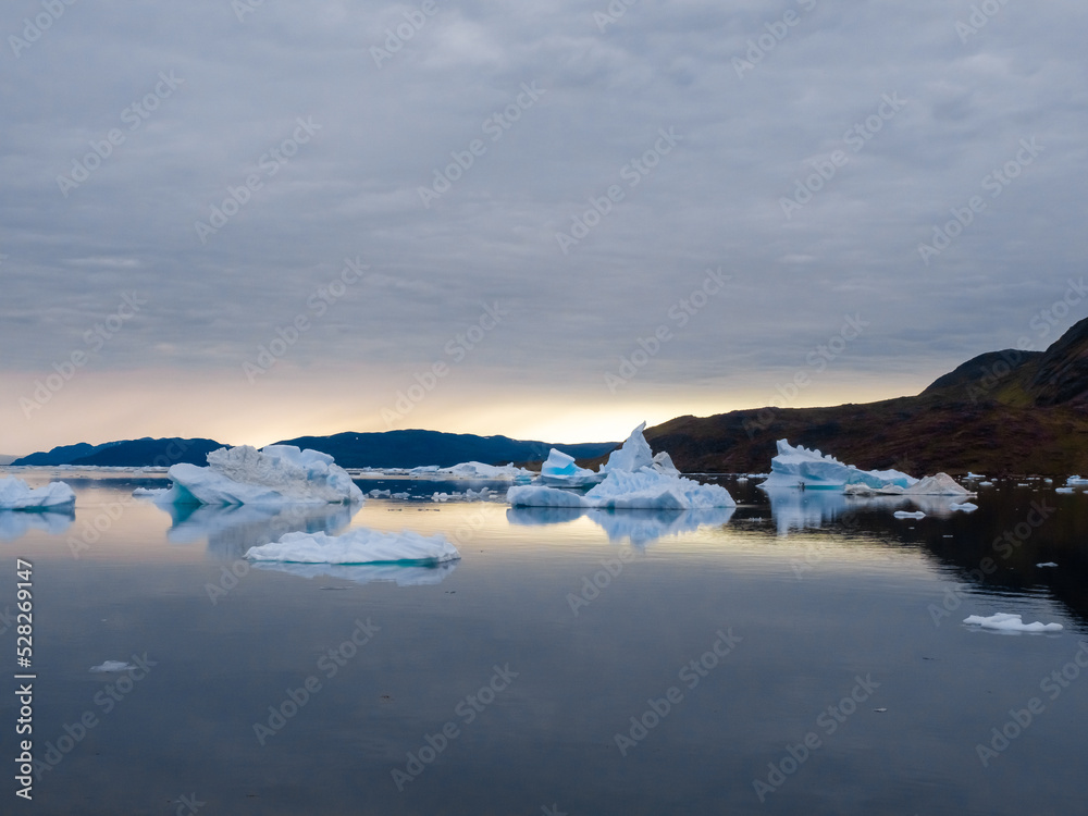 Obraz premium The iceberg filled waters of the Tunulliarfik and Sermilik Fjords on the shores of the port settlement of Narsaq, Southern Greenland
