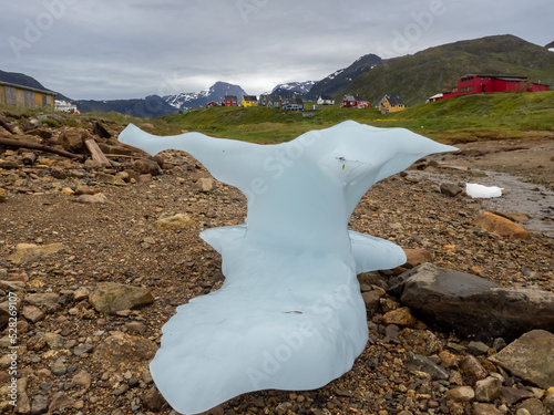 Stranded iceberg on the shores of the port settlement of Narsaq, Southern Greenland photo