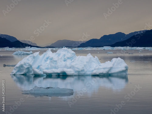 Midnight sun on the shores of Narsaq  Southern Greenland  where the waters of the Tunulliarfik and Sermilik Fjords are filled with numerous icebergs from the nearby glaciers.