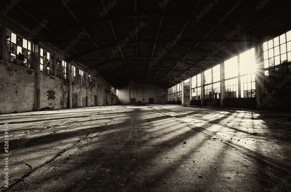 Old abandoned factory building or warehouse on a sunny summer day