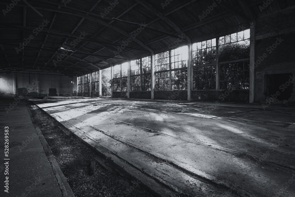 Old abandoned factory building or warehouse on a sunny summer day