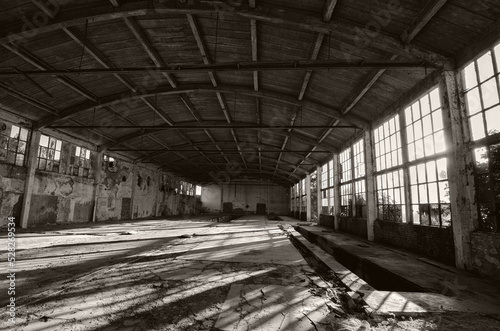 Old abandoned factory building or warehouse on a sunny summer day