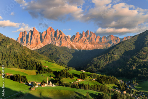 Afterglow over the Odle Ridge in the idyllic Dolomites mountains village St Madgalena, Val di Funes, in South Tyrol, Italy photo