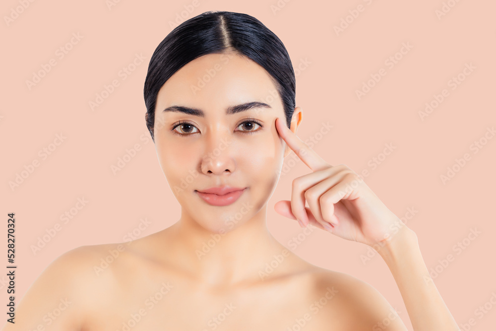 Beauty asian woman picking corner of her eye Beautiful girl get anti age treatment for wrinkles and crow's feet at corner of the eye Attractive young lady showing that she does not have crow's feet