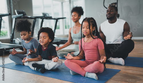 children exercise yoga with family at the gym.The lifestyle of a young body is to take care of one's body.Children wear sports wear to exercise fluently.