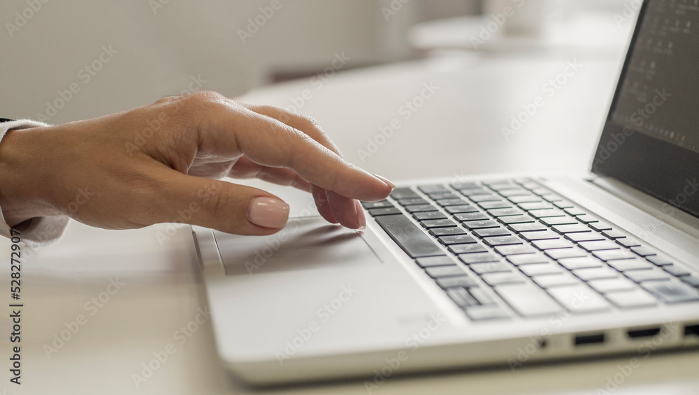 female hands use a laptop in the office.