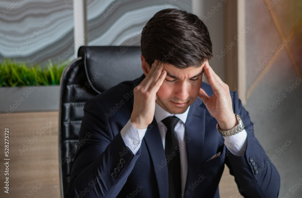 portrait of young businessman in a dark blue suit working in the office portrait of young businessman in a dark blue suit working in the office