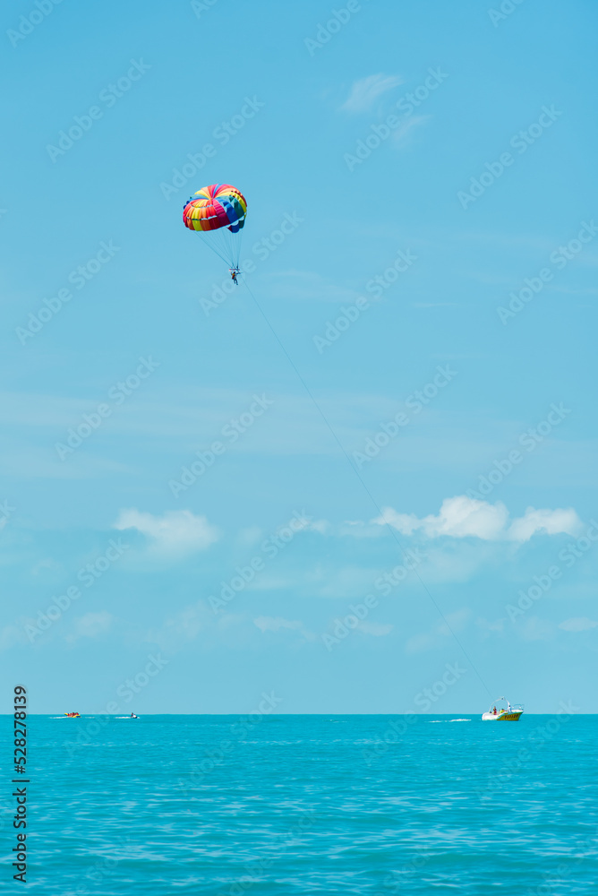 Rainbow parachute on the background of the blue sea and sky. Landscape. Summer. Vacation. Rainbow parachute on the background of the blue sea and sky. Landscape. Summer. Vacation.