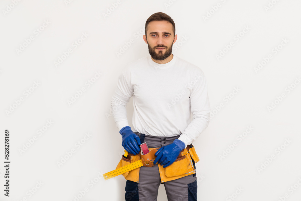 Man builder in a robe, overalls on a white background. Isolate, copy space Man builder in a robe, overalls on a white background. Isolate, copy space