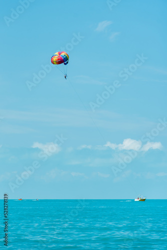 Rainbow parachute on the background of the blue sea and sky. Landscape. Summer. Vacation.
