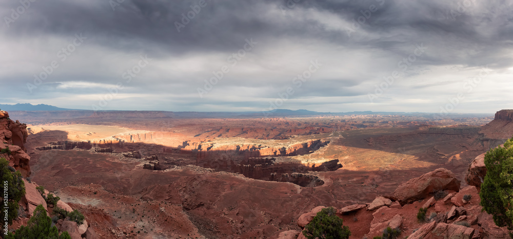 Scenic Panoramic View of American Landscape and Red Rock Mountains in Desert Canyon. Cloudy Sunset Sky. Canyonlands National Park. Utah, United States. Nature Background Panorama