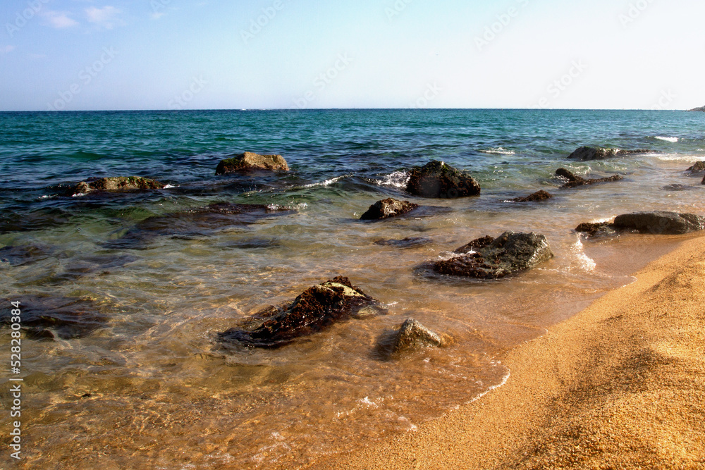 Waves, sea, beach, clear water. Stones under water. Spain. Waves, sea, beach, clear water. Stones under water. Spain.