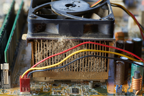 Old motherboard covered in dust and dirt. Close-up.