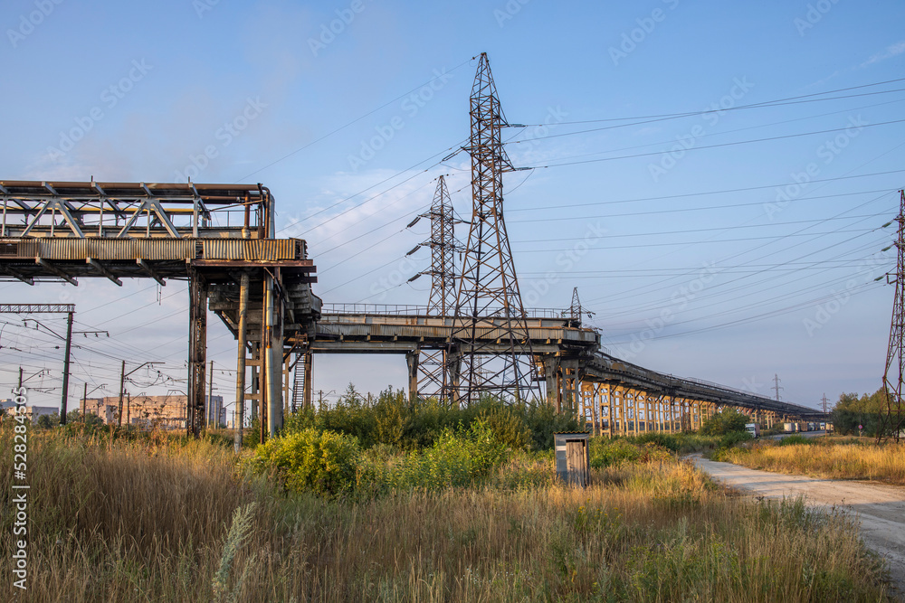 industrial landscape with heavy pollution produced by a large factory. Chemical plant. Pipes on the territory of the plant. power lines. industrial landscape with heavy pollution produced by a large factory. Chemical plant. Pipes on the territory of the plant. power lines.