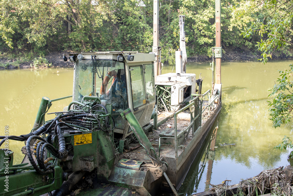 A dredge clears the bed of a small river.