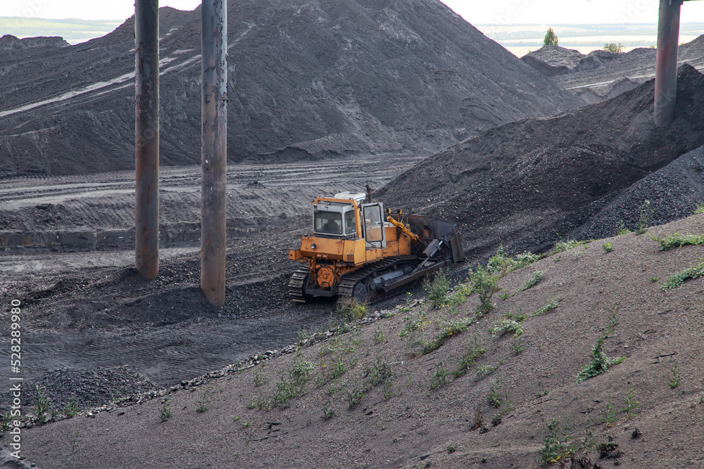 Tractor works in coal factory storage. Tractor works in coal factory storage.