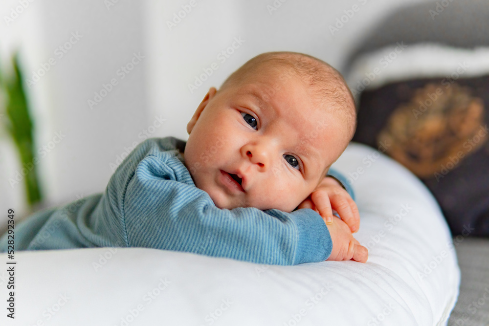 One month cute little Baby Resting on the pillow, looking in the camera One month cute little Baby Resting on the pillow, looking in the camera