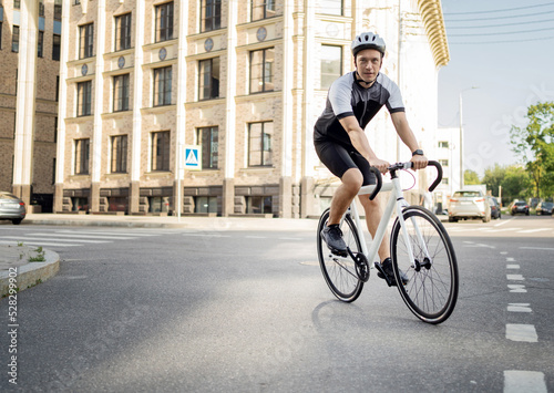 A cyclist rides a bike in the city, a bicycle suit and helmet on an athlete