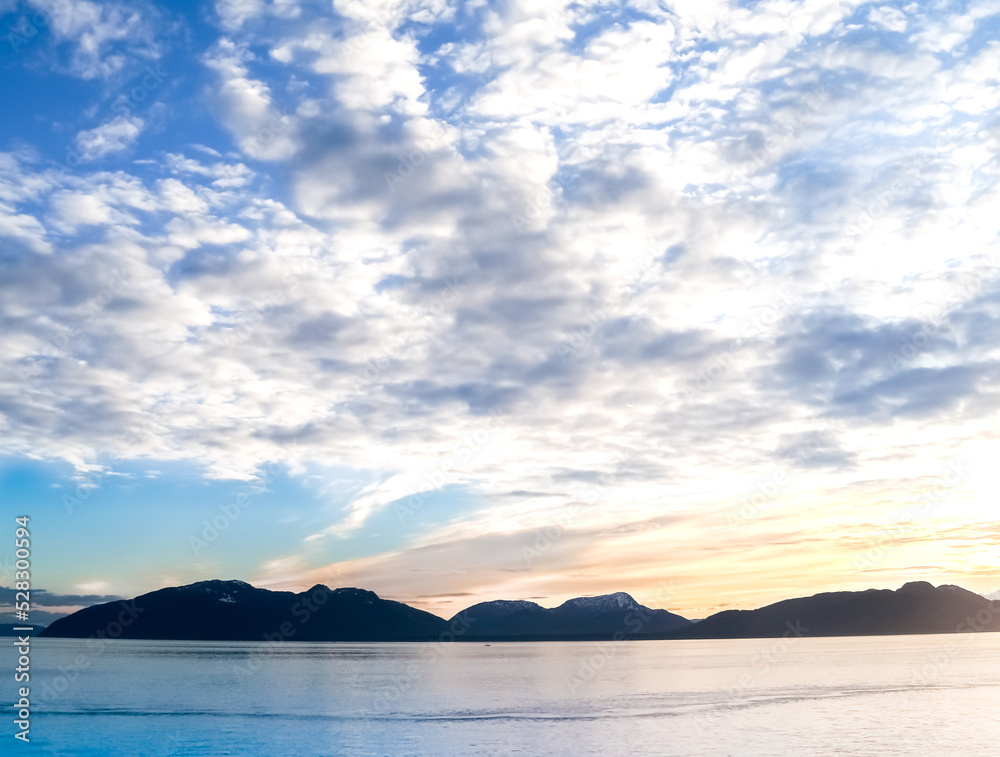 Sunset and silhouette distant hills and land in Alaska Sunset and silhouette distant hills and land in Alaska