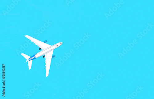 Airplane on a blue background, travel concept.