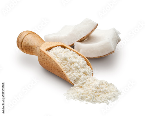 Coconut flour scattered from wooden scoop isolated on white