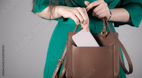 woman hand phone with bag pocket photo