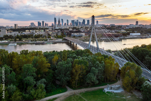 Panorama of Warsaw in Poland with Siekierkowski bridge over Vistula river during sundown.
