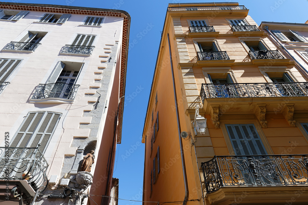 Looking up at the architectural details of an old apartment building in Toulon, France.