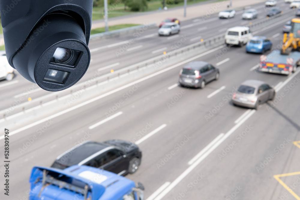 Fototapeta premium Closeup of traffic security camera surveillance (CCTV) on the road in the big city