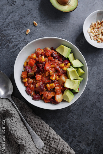 Chili con carne with avocado served on plate