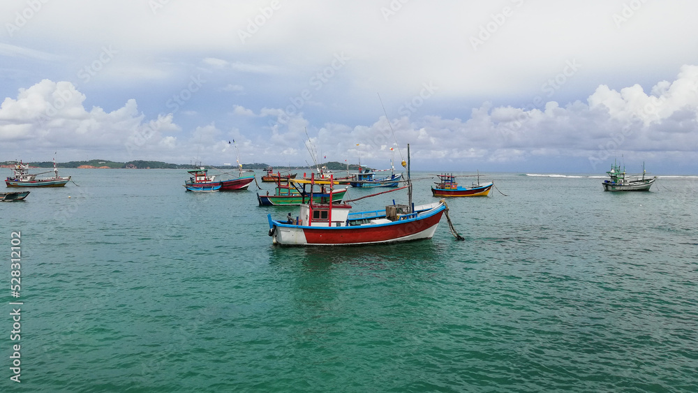 Colorful fishing boats at sea in Sri Lanka.