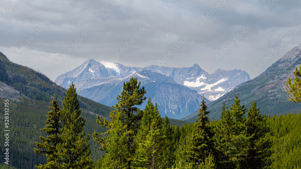 Great Rocky Mountains under magnificent clouds and sunlight, at Banff National Park, Calgary, Canada