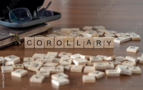 corollary word or concept represented by wooden letter tiles on a wooden table with glasses and a book