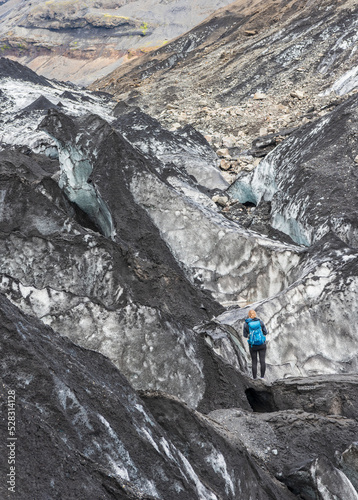 Hiker woman on glacier in Skaftafell National Park, Eastern Iceland, Northern Europe. Solheimajokull Glacier