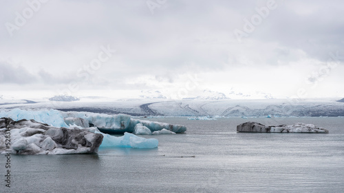 iceberg melts in the turquoise ocean bay. Huge high ice glacier in a polar nature environment. Arctic winter landscape in the problem of global warming. Timelapse of the ice and white snow of the dese photo