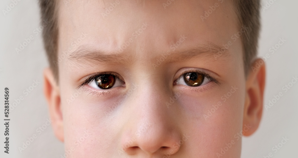 close-up of part of the child's face, boy 8-10 years old Asian-European appearance, human eye looking seriously at the camera, the concept of surveillance, peeping, tracking close-up of part of the child's face, boy 8-10 years old Asian-European appearance, human eye looking seriously at the camera, the concept of surveillance, peeping, tracking