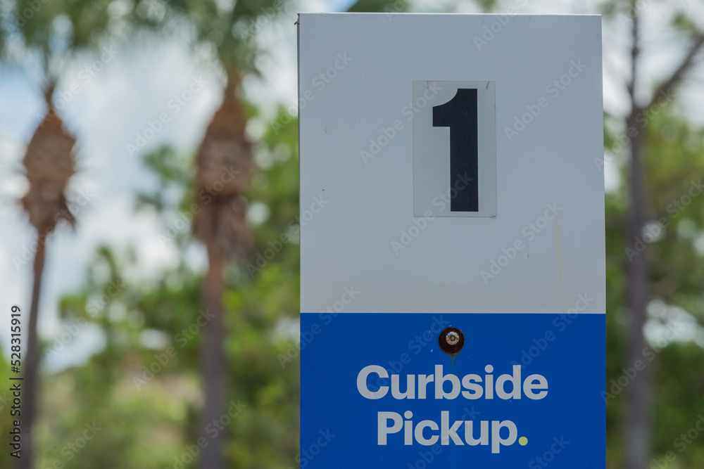 Curbside Pickup Sign in American Parking Lot During the Global Pandemic with the Number One on It - obrazy, fototapety, plakaty 