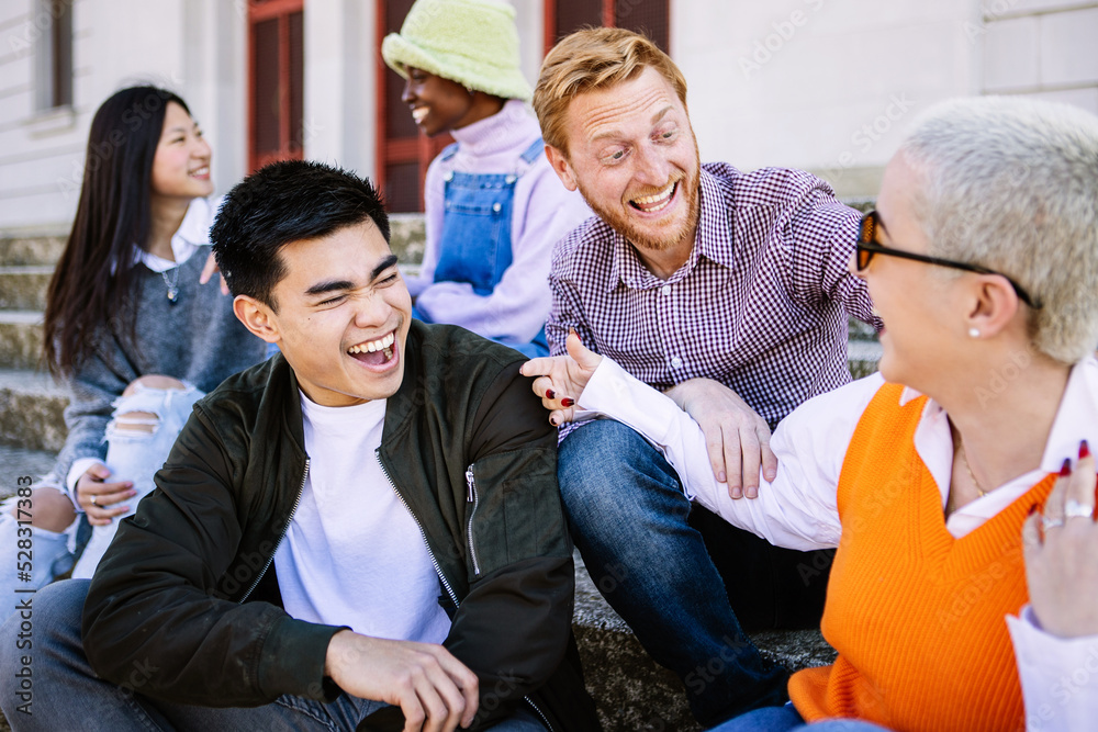 Happy young group of millennial friends having fun outdoors - Multiracial teenage people smiling and enjoying time together in city street Happy young group of millennial friends having fun outdoors - Multiracial teenage people smiling and enjoying time together in city street