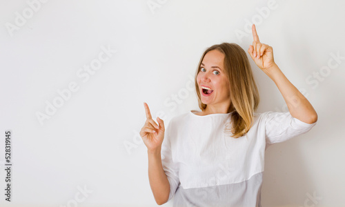cheerful woman  promoter point index finger suggest select adverts promo over white background