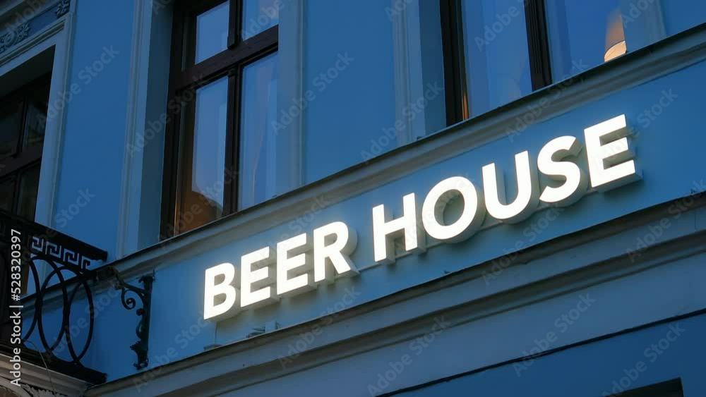 Modern BEER HOUSE illuminated sign on a pub's facade Modern BEER HOUSE illuminated sign on a pub's facade