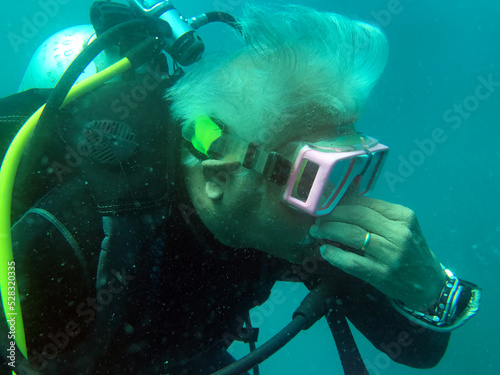 Close-Up of an active senior man scuba diving, Mu Ko Similan National Park, Similan Islands, Thailand