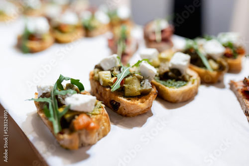 Caprese bruschetta toasts with cherry tomatoes, mozzarella and basil. Top view with space for your text