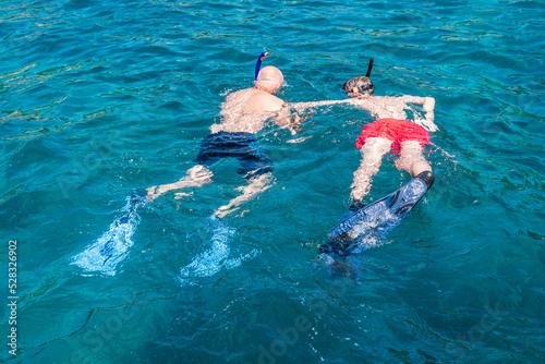 two persons snorkeling in the sea