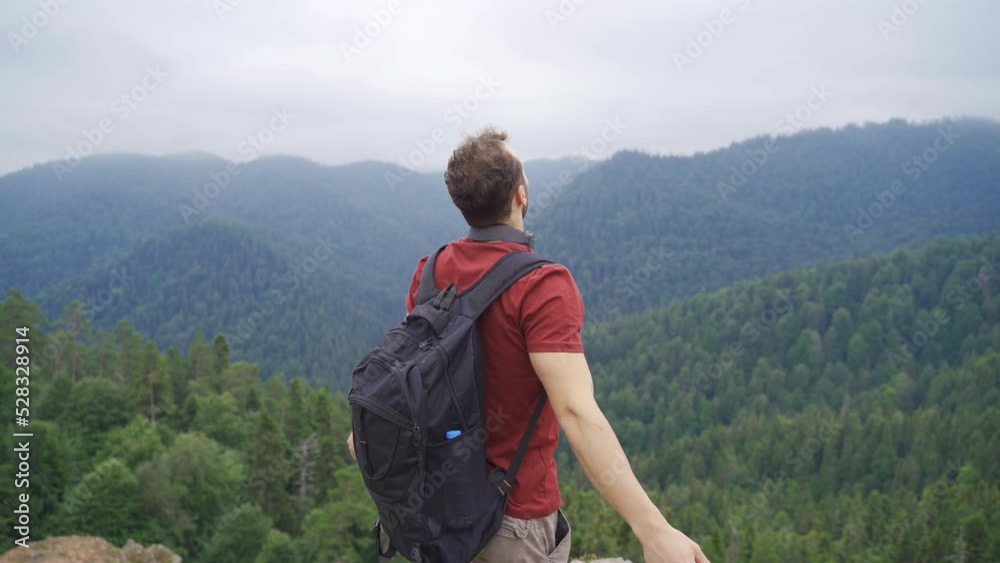 The man who spreads his hands at the summit.
Free man watching the forests at the summit.
