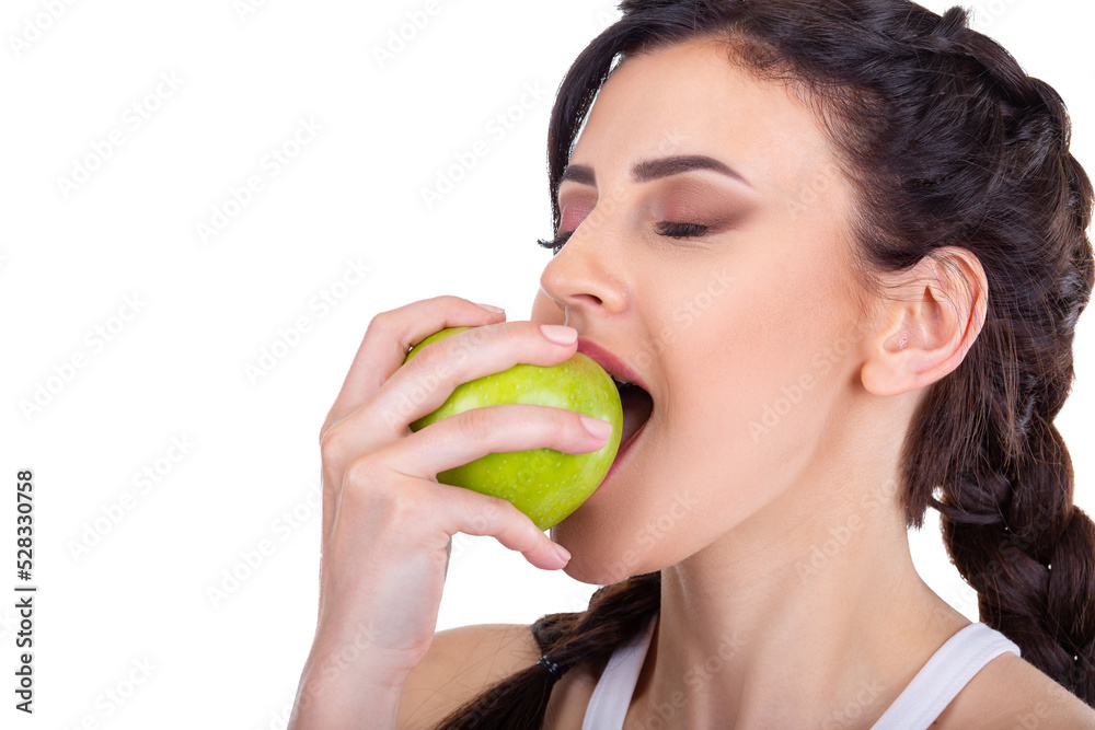 Beautiful young brunette girl eating a green fresh apple isolated on white background Beautiful young brunette girl eating a green fresh apple isolated on white background