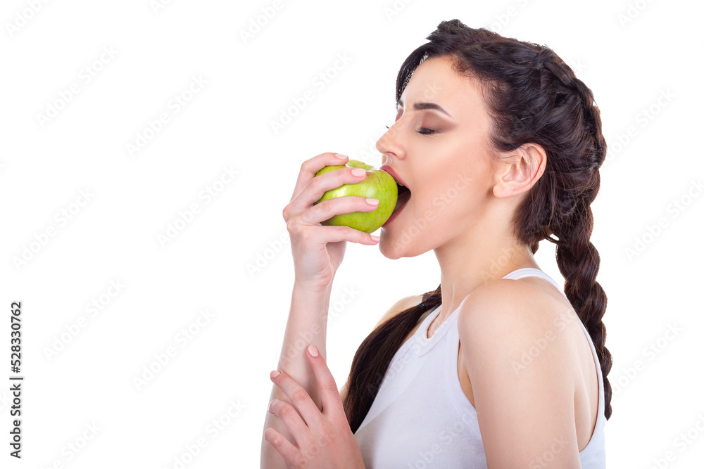 Beautiful young brunette girl eating a green fresh apple isolated on white background Beautiful young brunette girl eating a green fresh apple isolated on white background