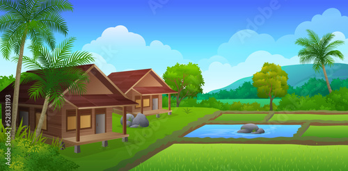 Traditional wooden house on the edge of rice fields with beautiful natural landscape