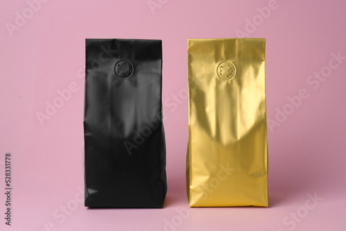 Different blank foil packages on pink background